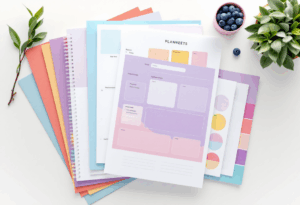 Stack of colorful printable planners and worksheets ready for instant use.
